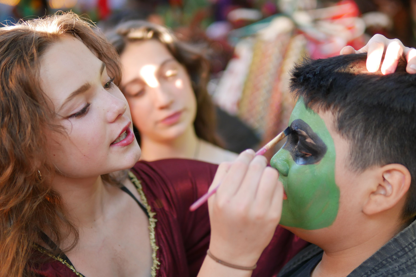 A staff member painting a campers face