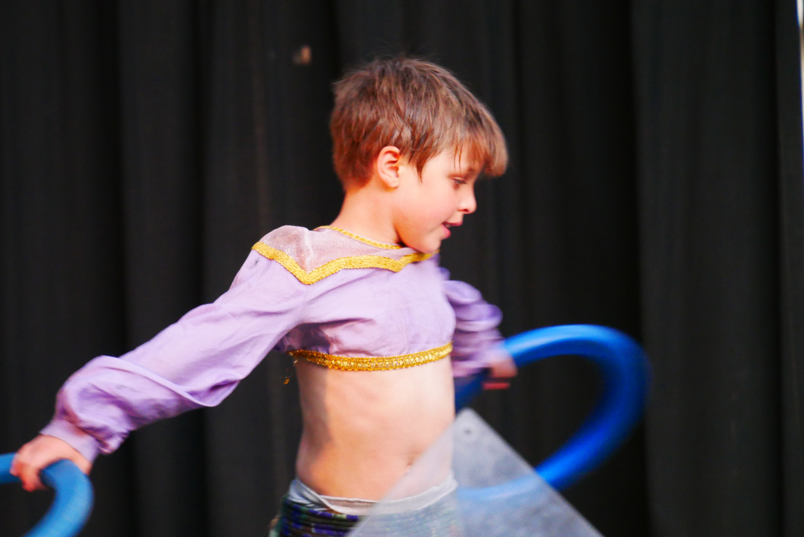 A camper performing a dance routine on stage